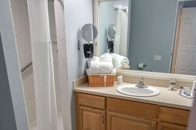 Photo of bathroom with a standing shower and white towels