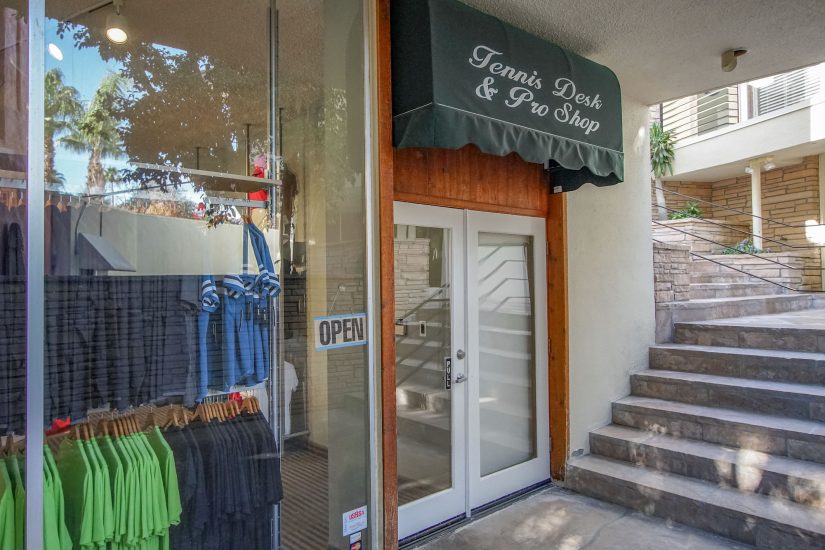 Photo of Store Entrance with a sign saying: Tennis Desk and Pro Shop