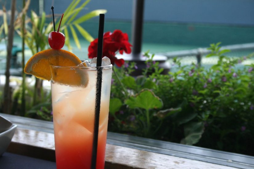 Photo of Cocktail with an orange, cherry and straw